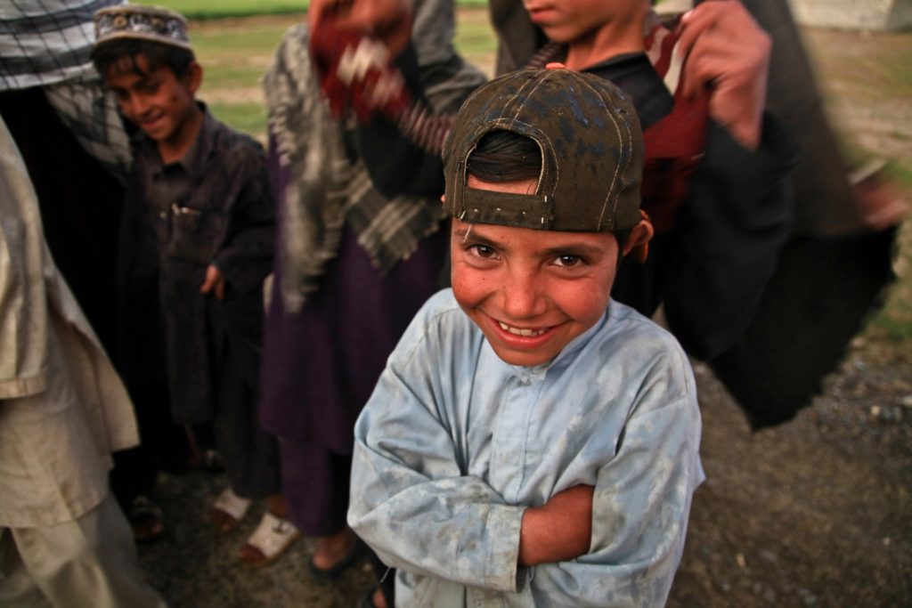 Impoverished young Afghani boy smiling